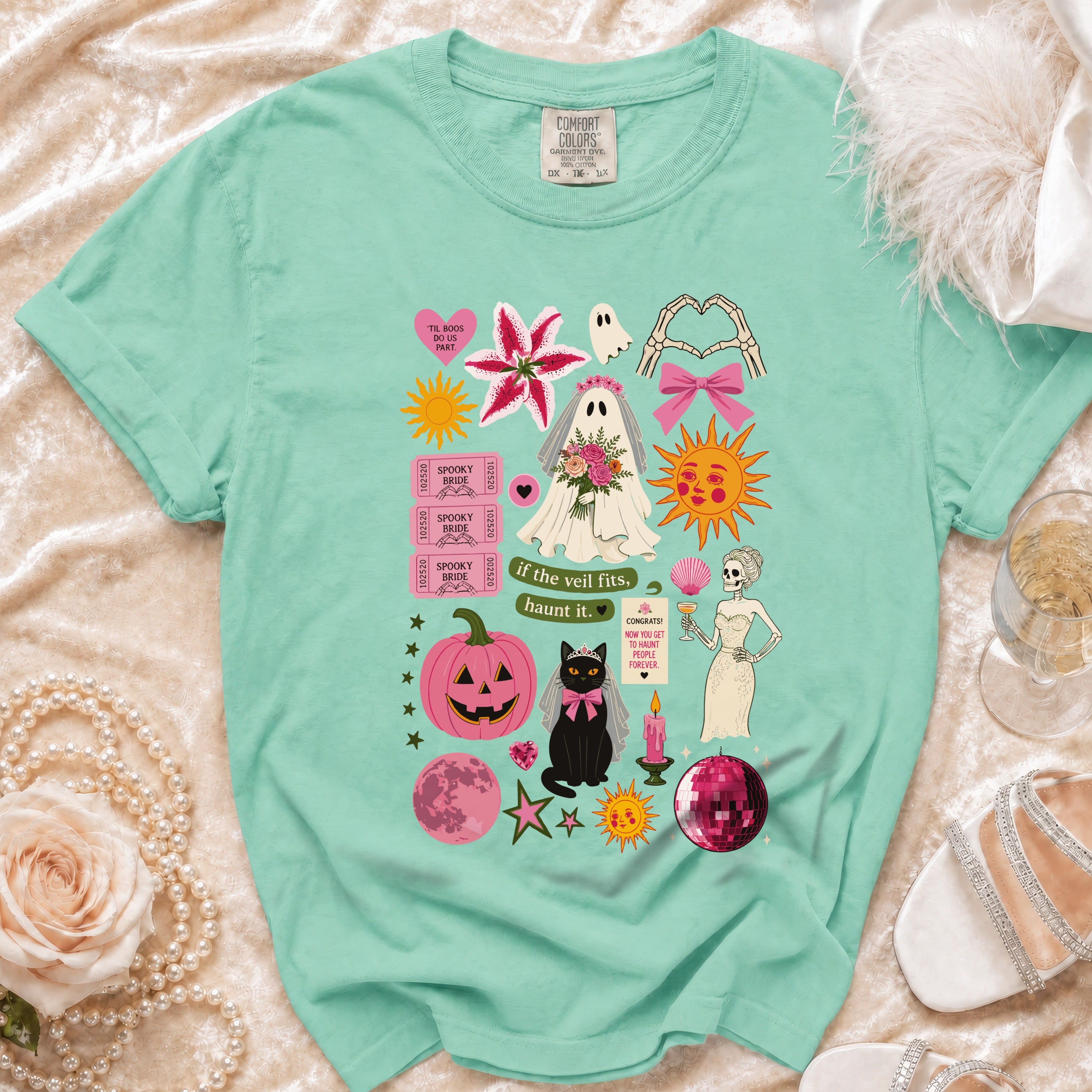 Mint t-shirt with spooky bride, ghost, cat, and Halloween-themed graphics.