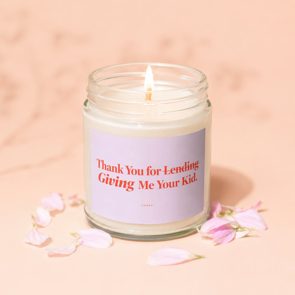 Lit candle in a jar with a lavender label reading "Thank You for Lending Giving Me Your Kid."