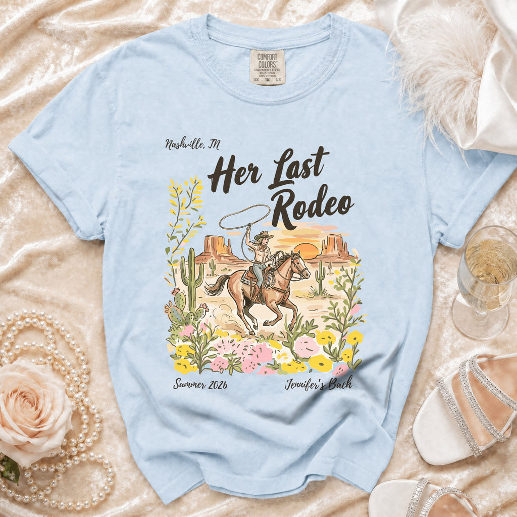 Light blue t-shirt with "Her Last Rodeo" and a cowgirl scene.