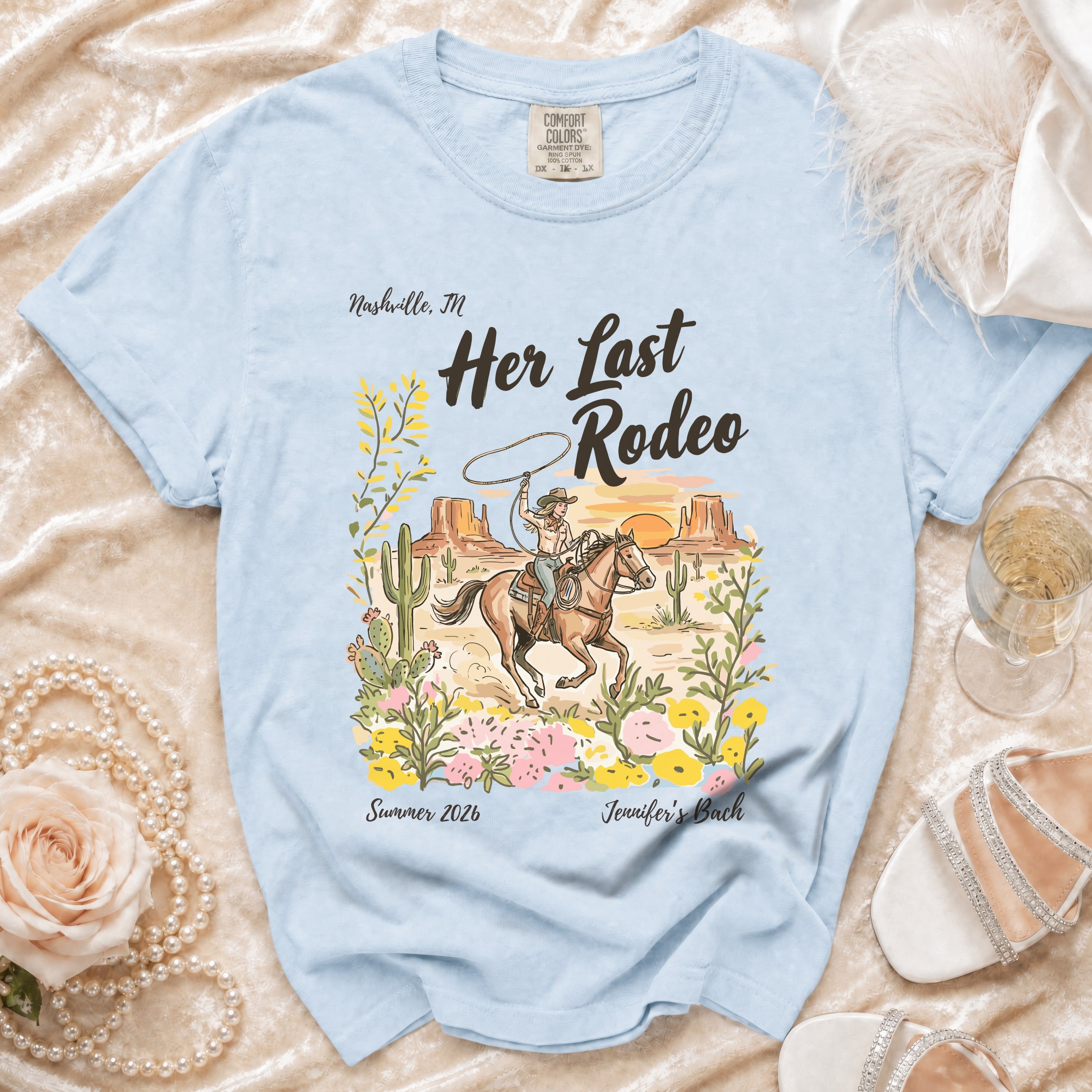 Light blue t-shirt with "Her Last Rodeo" and a cowgirl scene.