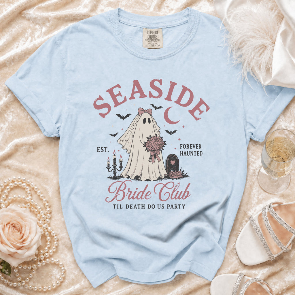 Light blue t-shirt with ghost bride graphic: "Seaside Bride Club", "Til Death Do Us Party".