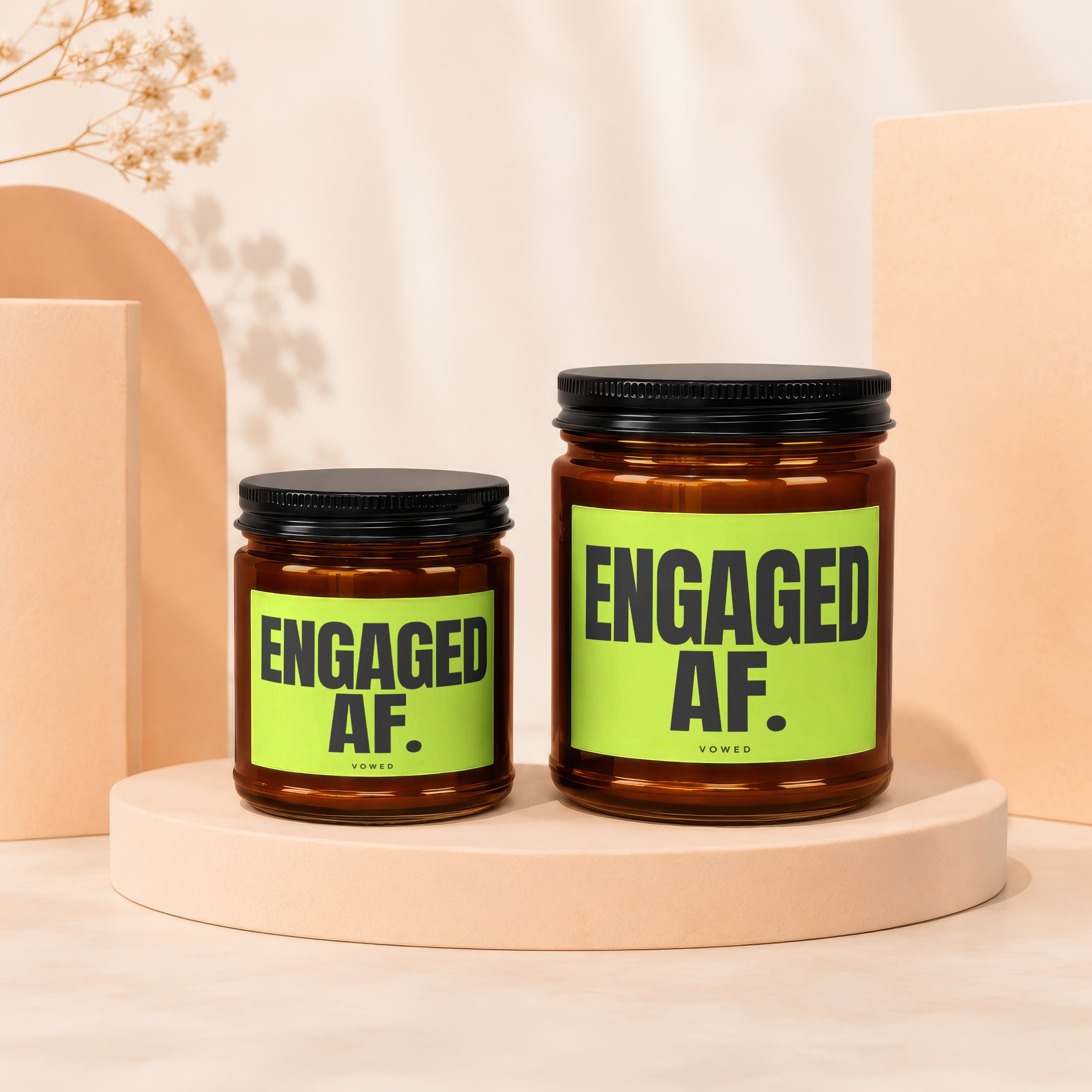 Two amber glass candles with black lids and "ENGAGED AF." labels.