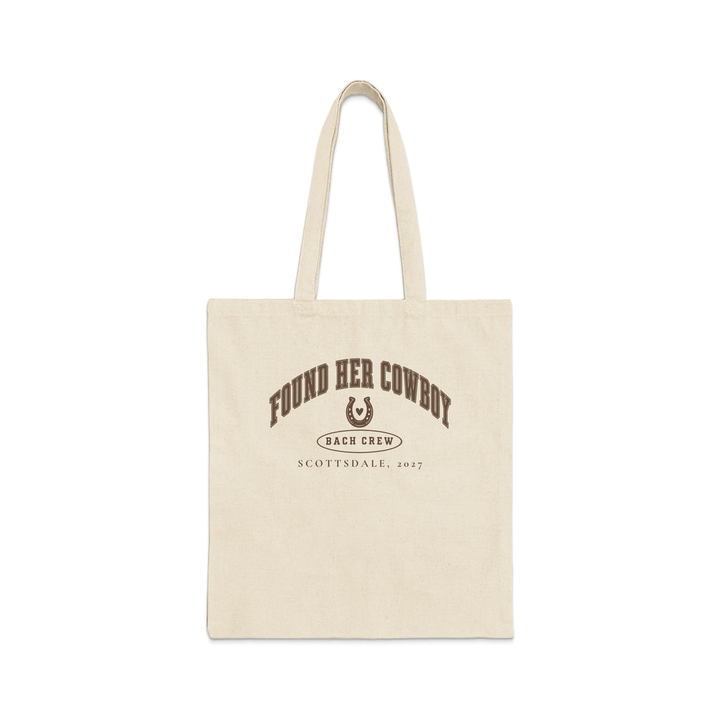 A cream-colored canvas tote bag featuring brown arched text reading FOUND HER COWBOY, a horseshoe, and SCOTTSDALE, 2027.
