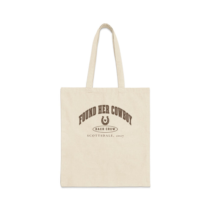 A cream-colored canvas tote bag featuring brown arched text reading FOUND HER COWBOY, a horseshoe, and SCOTTSDALE, 2027.