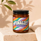 Amber jar candle with colorful "FINALLY! WE CALLED IT ON DATE THREE" label.