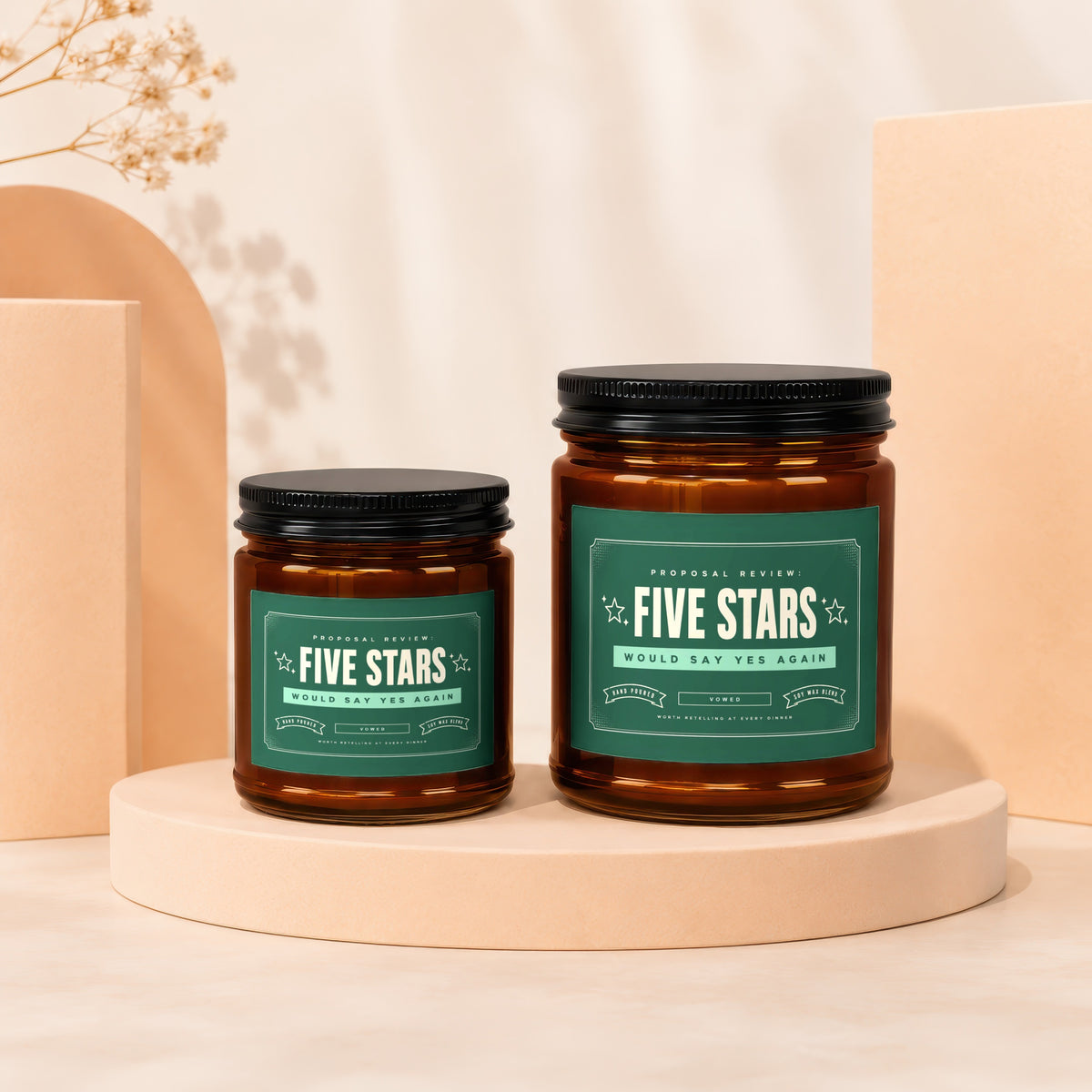 Two glass jar candles with green labels reading "Five Stars" and "Would Say Yes Again".