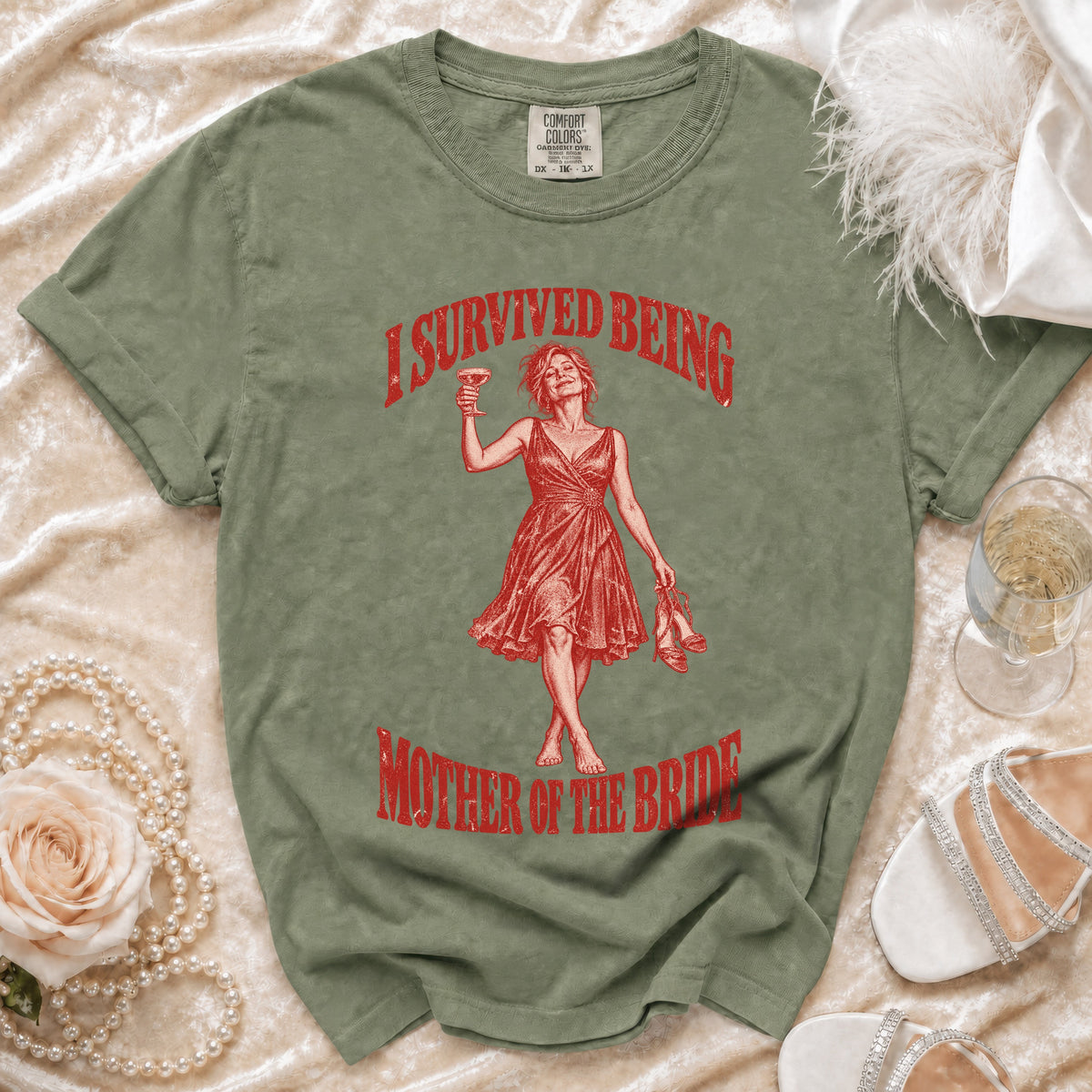Green t-shirt with red distressed graphic "I survived being mother of the bride".