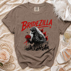 Brown t-shirt with a graphic of "Bridezilla" Godzilla in a wedding veil holding flowers over a city.