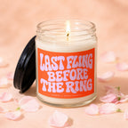 Glass candle with a lit wick and a label reading "LAST FLING BEFORE THE RING".