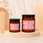 Two amber glass candles with black lids, labeled "Last Fling Before The Ring."