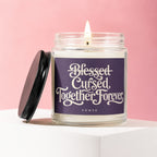 Glass candle with "Blessed Cursed Together Forever Vowed" inscribed on label.