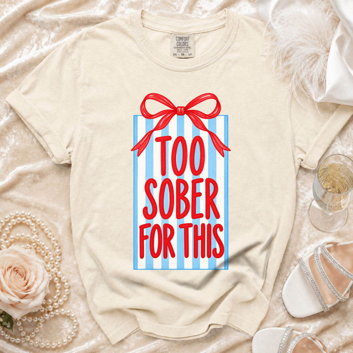 Cream t-shirt with red and blue "Too Sober For This" gift box graphic.