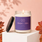 Harper + Miles candle with purple label, lit flame, and lid off.