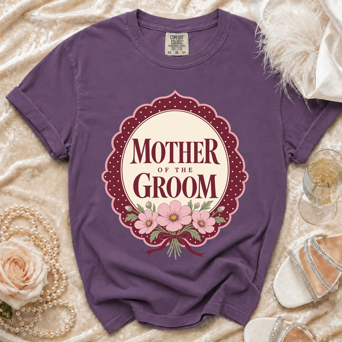 Purple t-shirt with "Mother of the Groom" text and floral design.