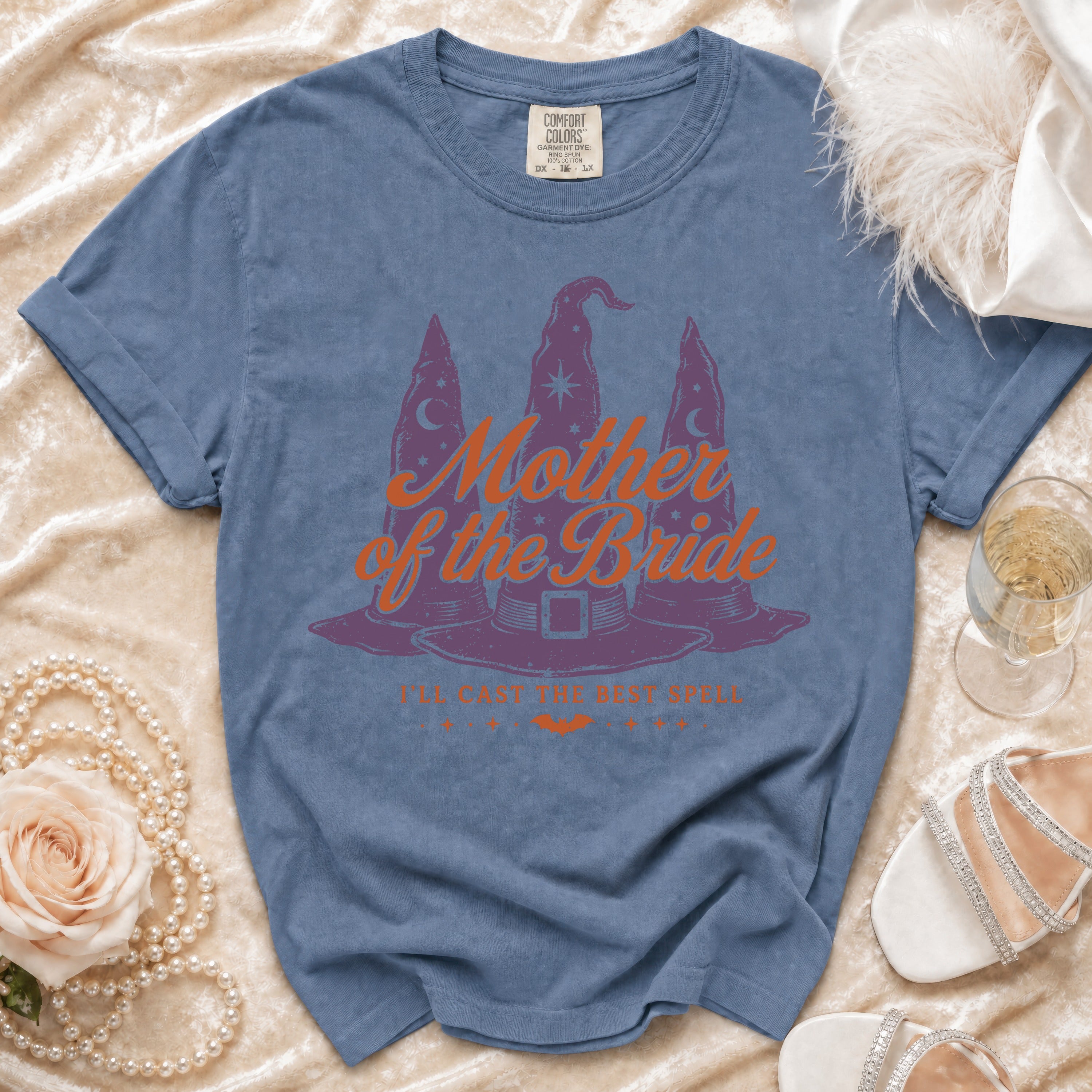 Blue t-shirt with "Mother of the Bride" text and witch hats graphic.