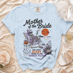 Light blue t-shirt with "Mother of the Bride" and a skeleton on a beach chair.
