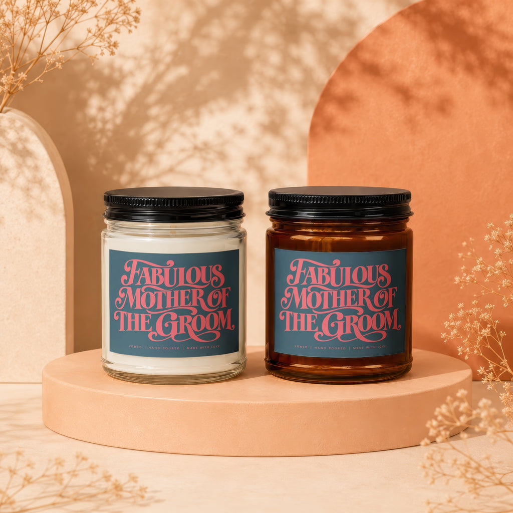 Two candles, one white and one amber, labeled "Fabulous Mother of The Groom."