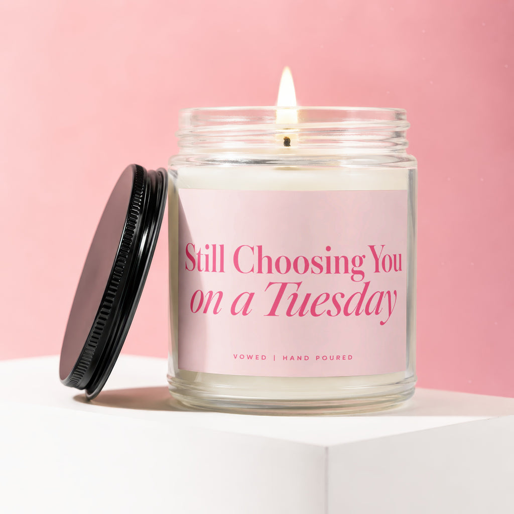 Jar candle with pink label reading "Still Choosing You on a Tuesday".