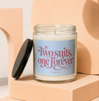 Glass candle with black lid, reads "Two suits, one forever" and "VOWED".