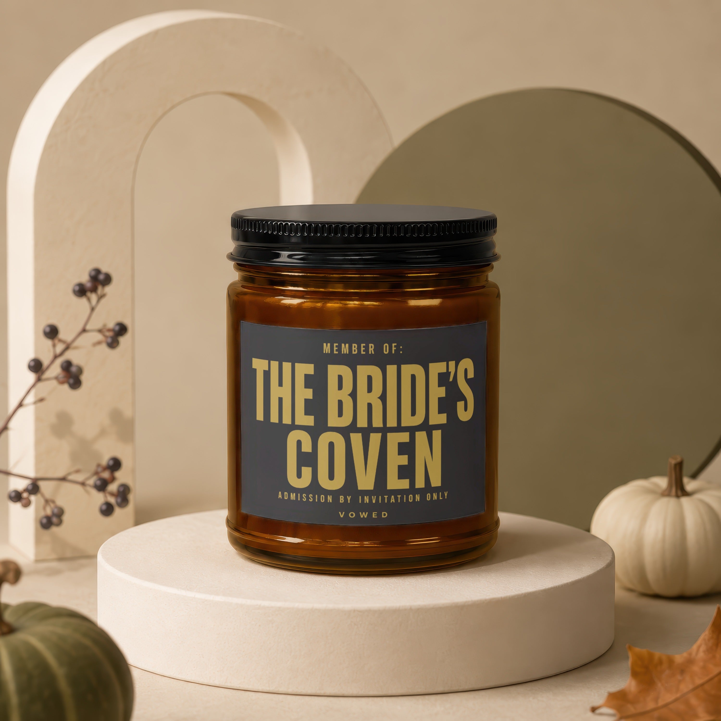 Amber jar candle with black lid, label reads "Member of: The Bride's Coven, Admission by Invitation Only, Vowed".