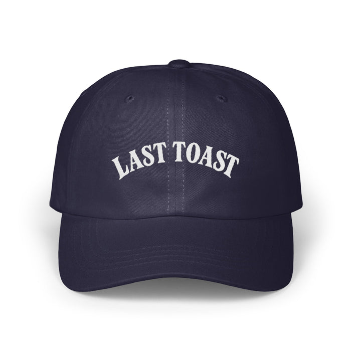 Navy blue baseball cap with white embroidered text "LAST TOAST".