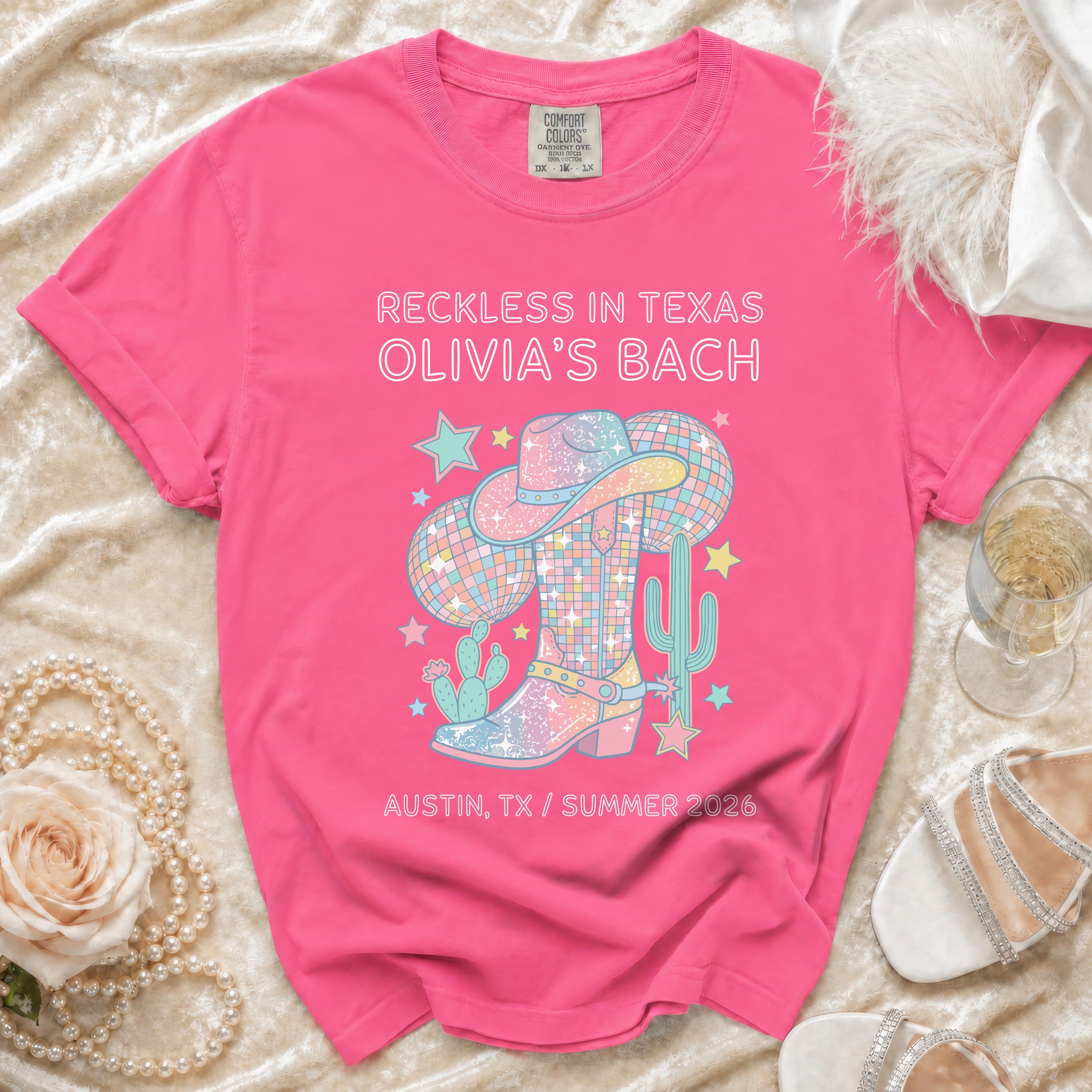 Pink t-shirt graphic for Olivia's Bach, Reckless in Texas, Austin, TX, Summer 2026.