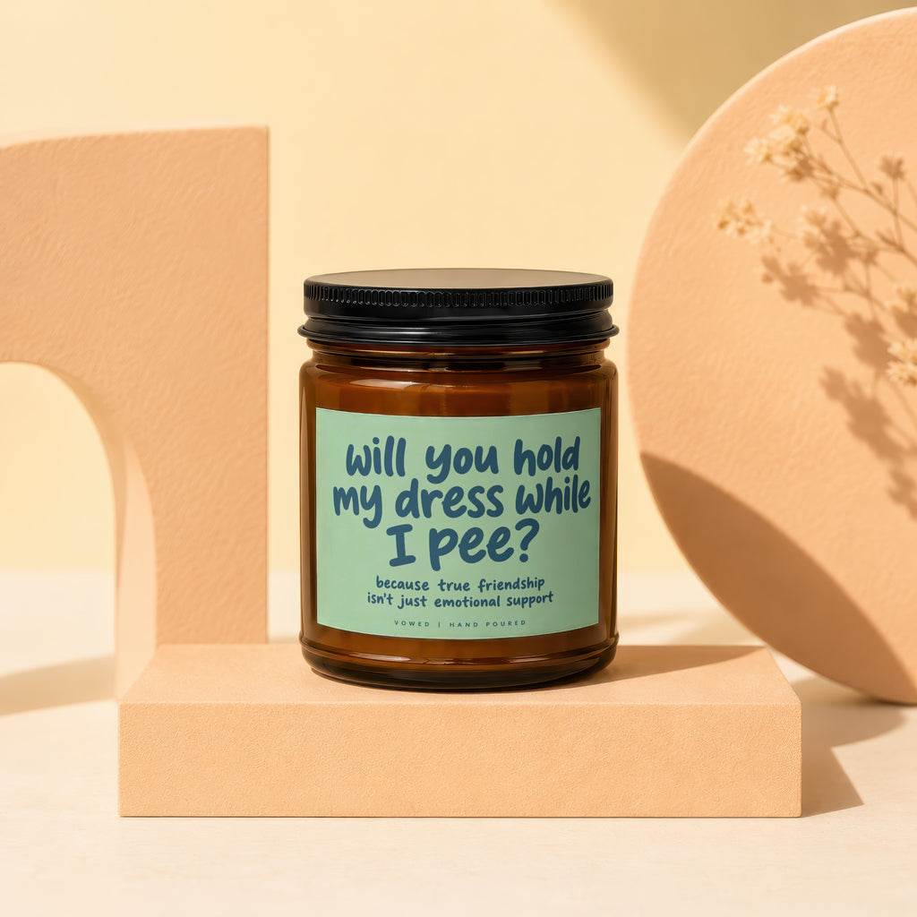 Brown candle in jar with black lid, text reads "will you hold my dress while I pee?".