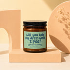 Brown candle in jar with black lid, text reads "will you hold my dress while I pee?".