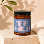 Candle with blue label reading "The Mr. & Mrs. Era."