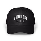 A black baseball cap with white embroidered text reading APRES SKI CLUB on the front.