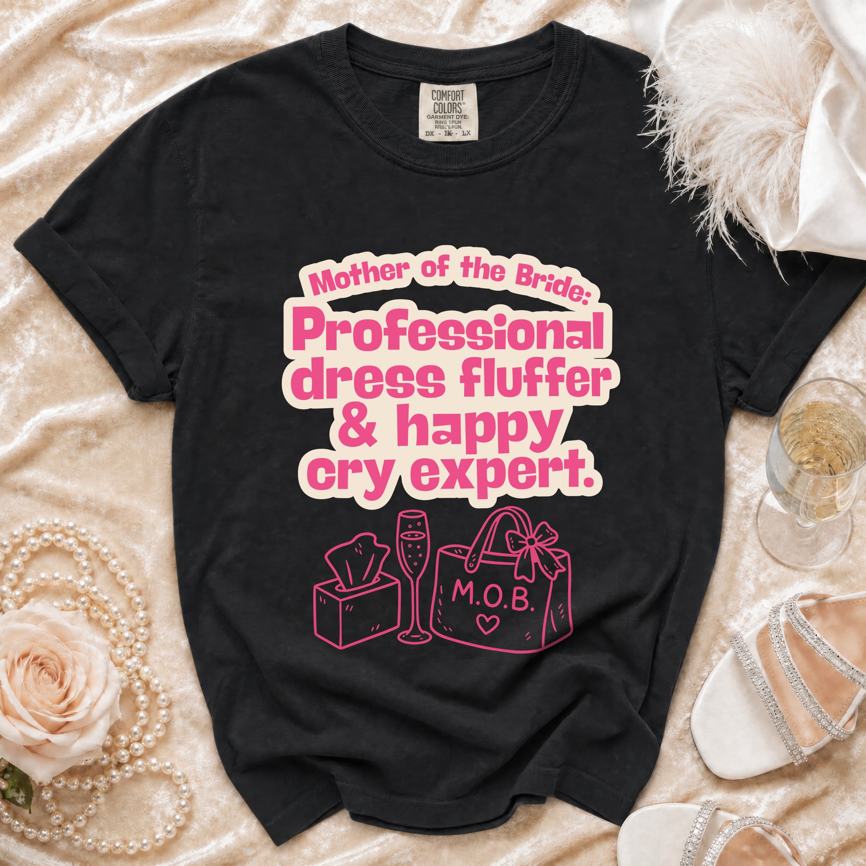 Black t-shirt with pink text: Mother of the Bride, Professional dress fluffer & happy cry expert.