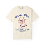 Cream t-shirt with "Her Last Rodeo" text and cowboy boots graphic.