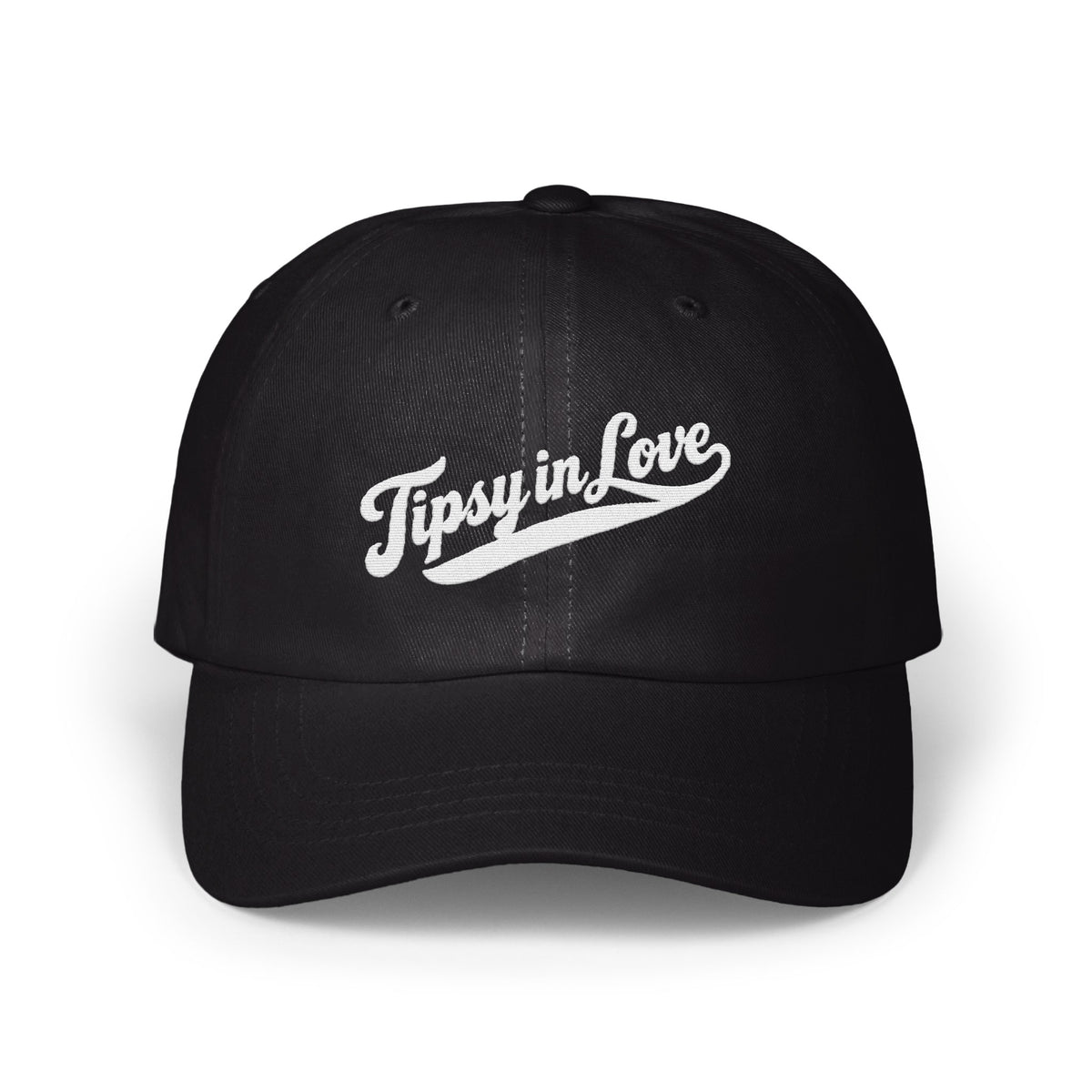A black baseball cap featuring white embroidered script that reads Tipsy in Love on the front panel.