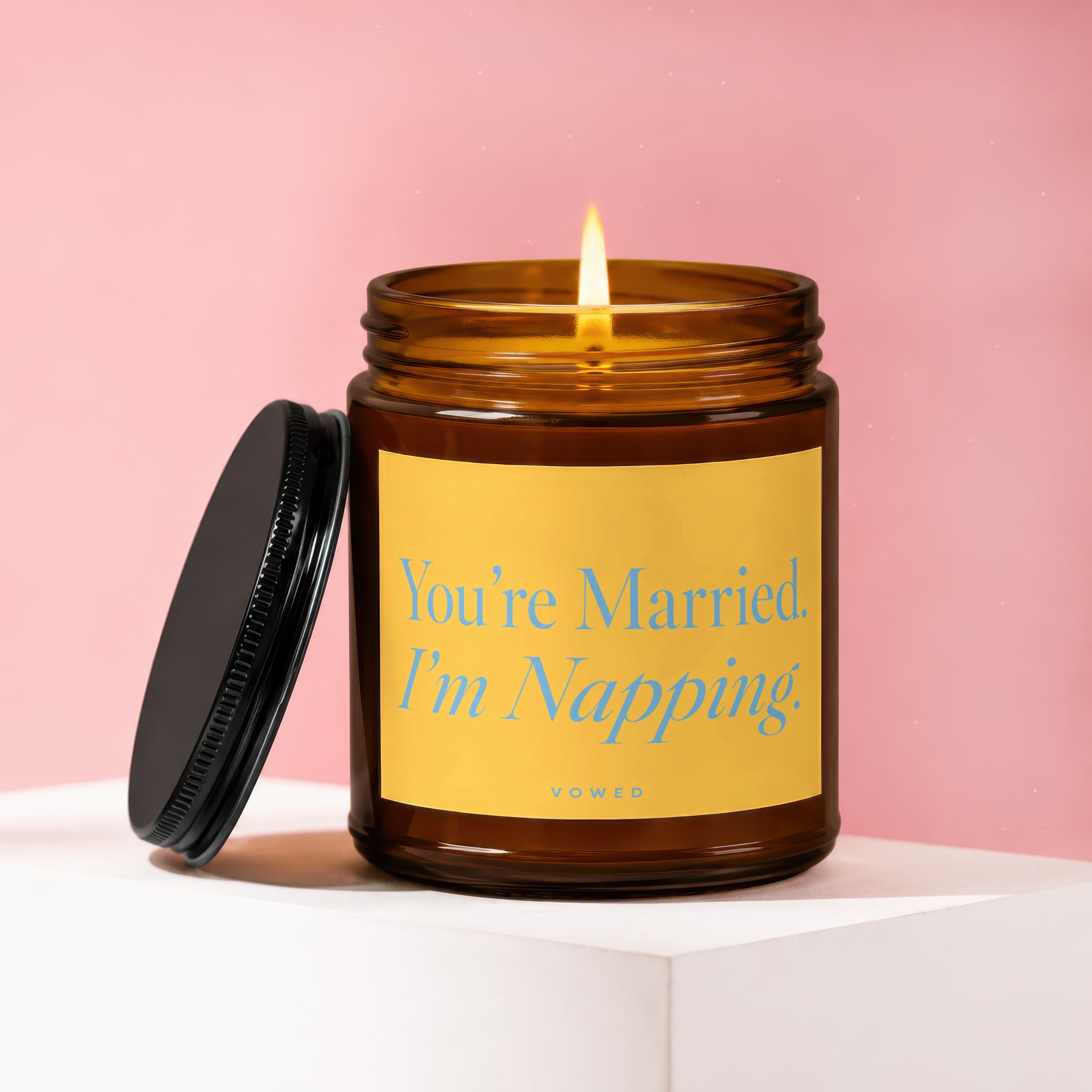 Amber jar candle with lid off, reading "You're Married. I'm Napping."