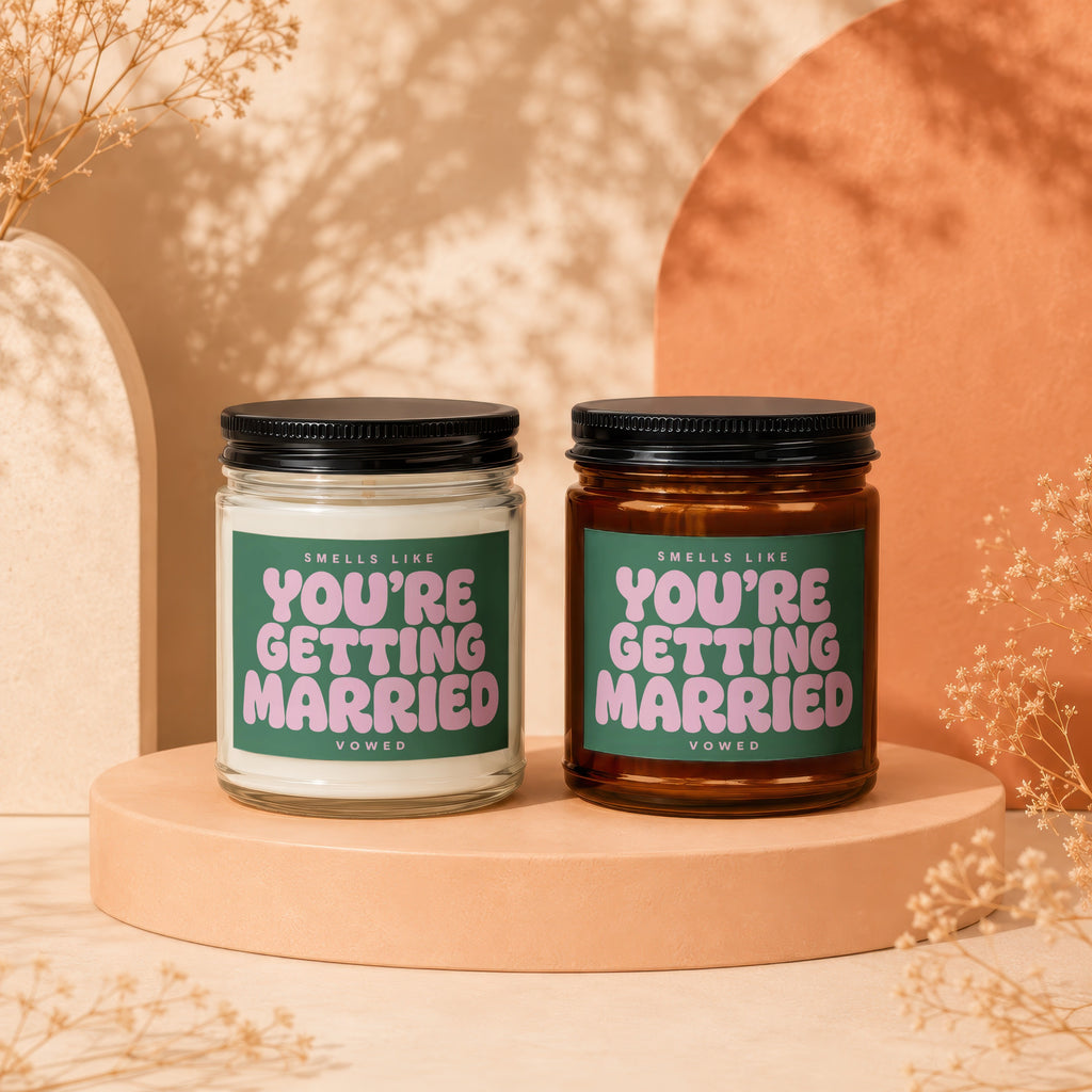 Two scented candles with "You're Getting Married" text on green labels.