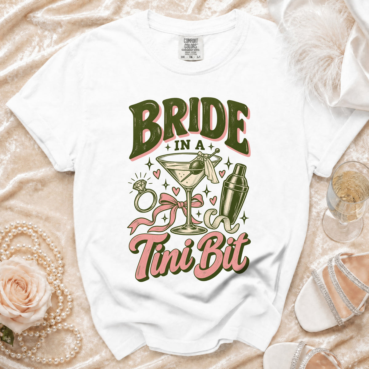 White t-shirt with "BRIDE IN A Tini Bit" graphic featuring a martini and shaker.
