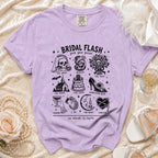 Lilac Comfort Colors t-shirt with "Bridal Flash" graphic and wedding-themed illustrations.