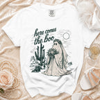 White t-shirt with "here comes the boo" text and a ghost bride in a desert scene.