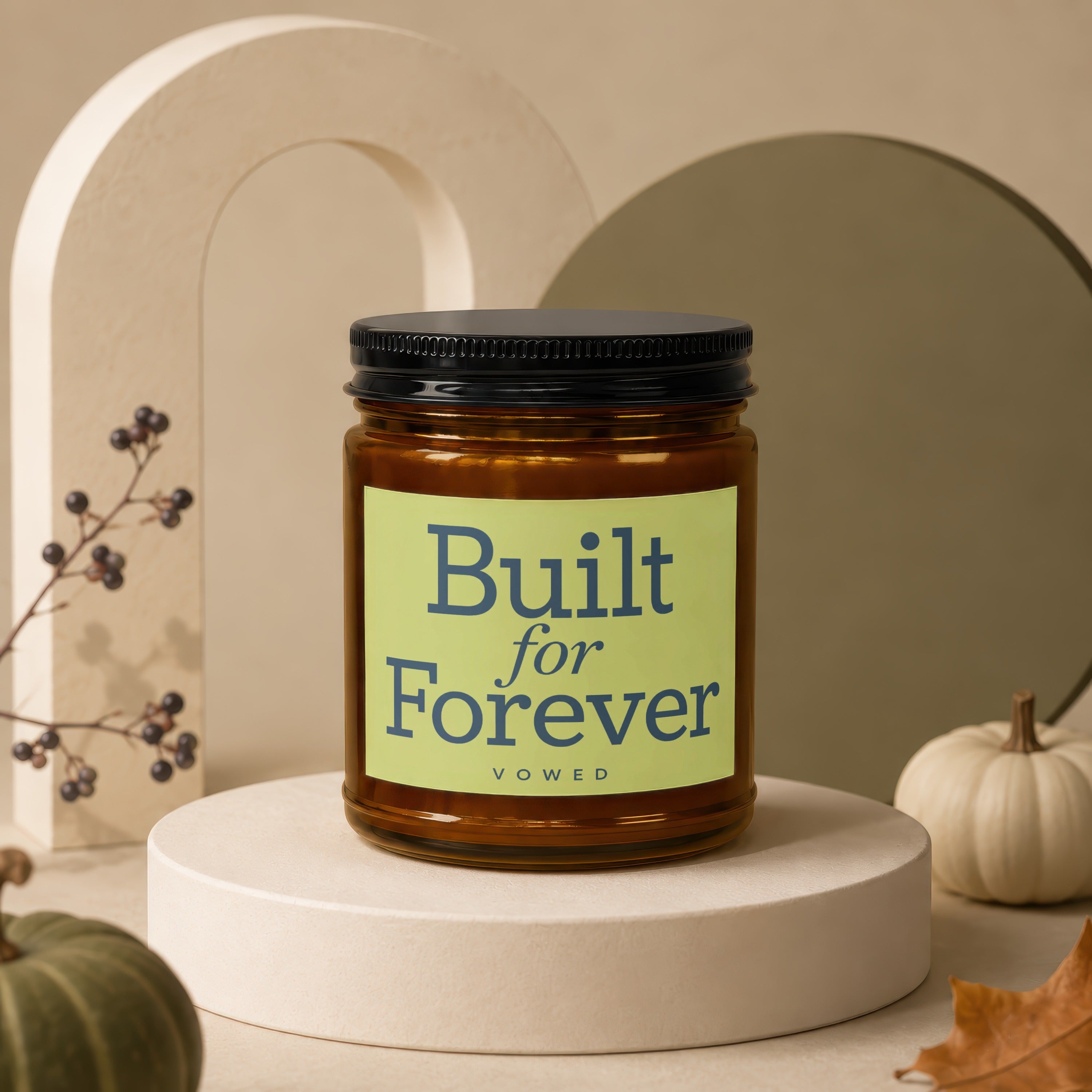 Amber jar candle with black lid on a pedestal, "Built for Forever" text.