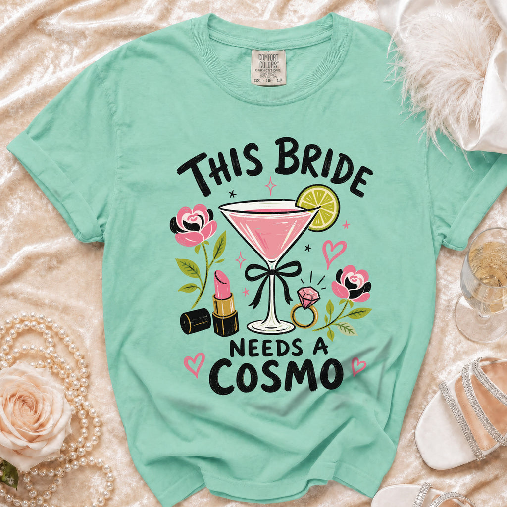 Mint green t-shirt with "This Bride Needs a Cosmo" graphic.