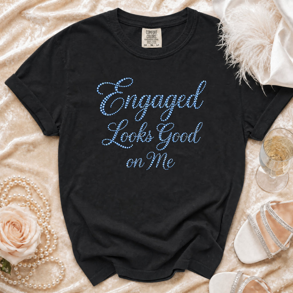 Black t-shirt with blue beaded text "Engaged Looks Good on Me".