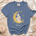Blue t-shirt with a bunny on a crescent moon and stars, saying "Starry-Eyed Bride".