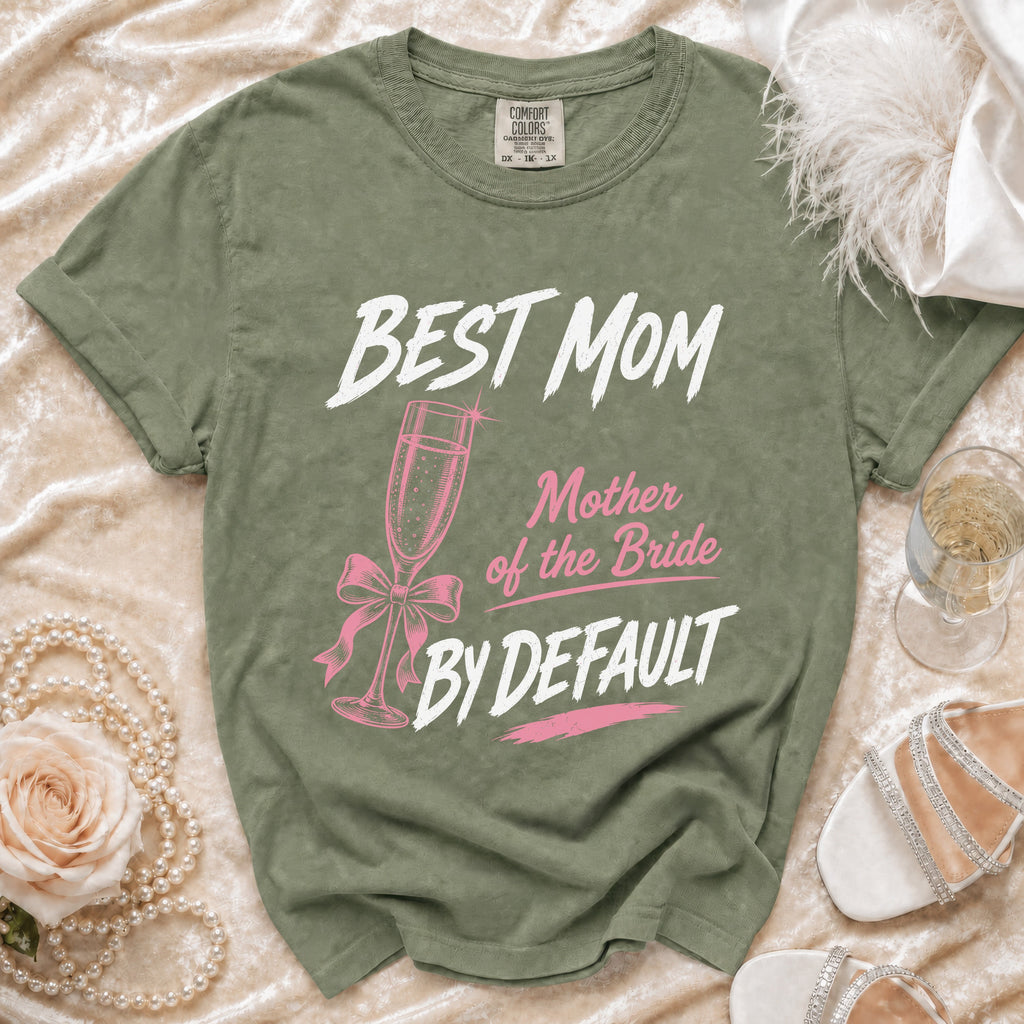 Olive green t-shirt with "BEST MOM Mother of the Bride BY DEFAULT" text and champagne flute graphic.