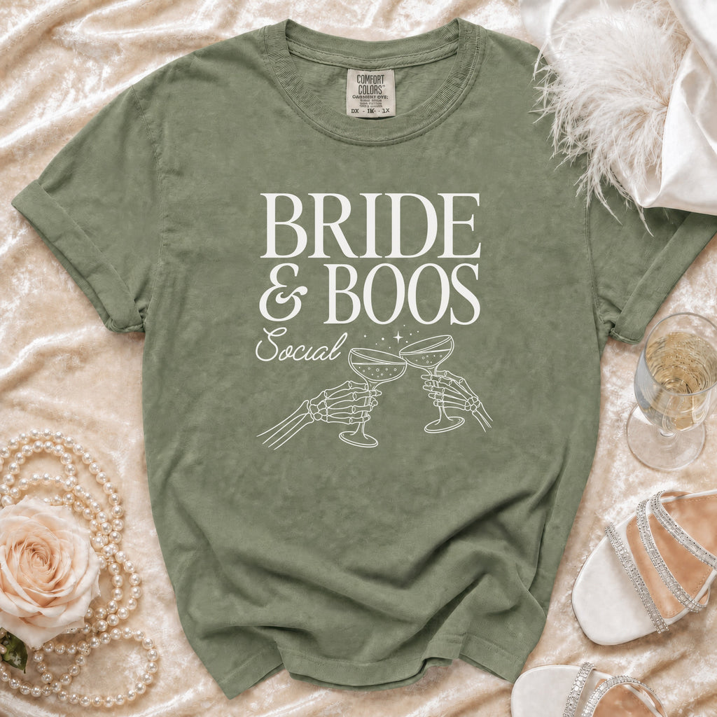 Olive green t-shirt with "BRIDE & BOOS Social" and skeleton hands toasting.