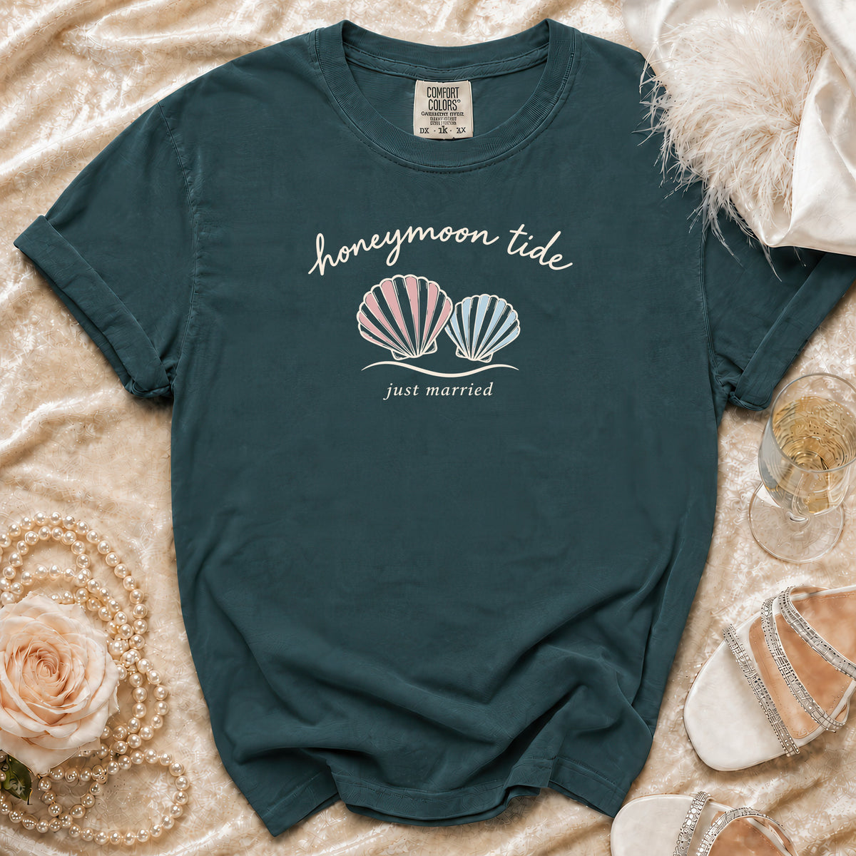 Dark teal t-shirt with "honeymoon tide just married" text and seashell graphic.