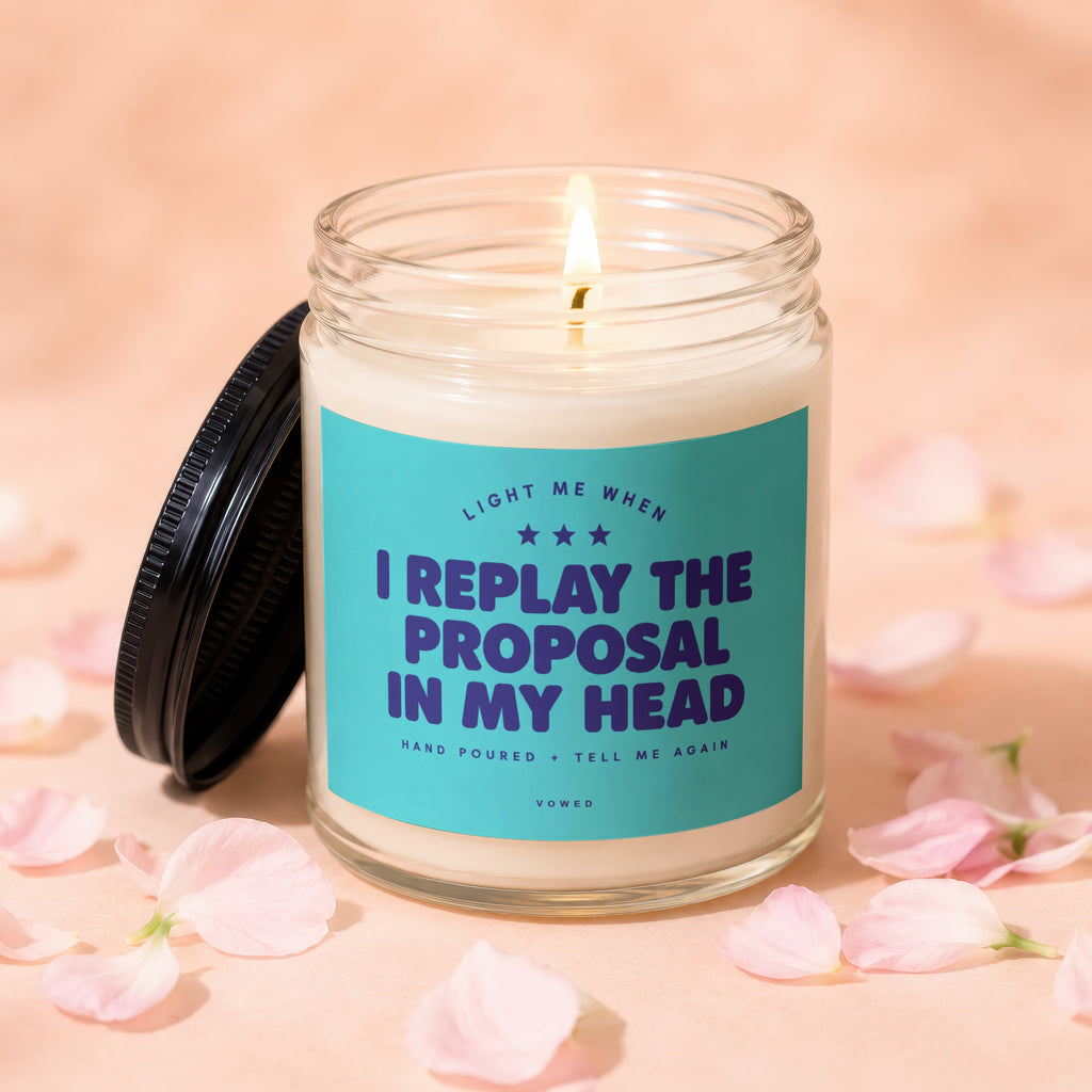 Lit candle with text "I replay the proposal in my head" on teal label.