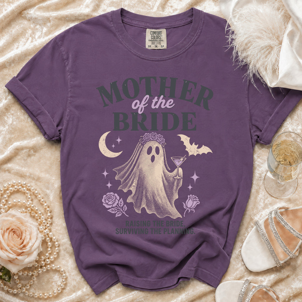 Purple t-shirt with "Mother of the Bride" text, ghost graphic, and "Raising the Bride, Surviving the Planning" tagline.