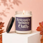 Candle labeled "Bridesmaid by Invitation Oath" with lid off, burning.