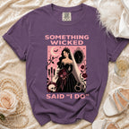 Purple t-shirt graphic with bride, skull, and text "Something Wicked Said 'I Do'".