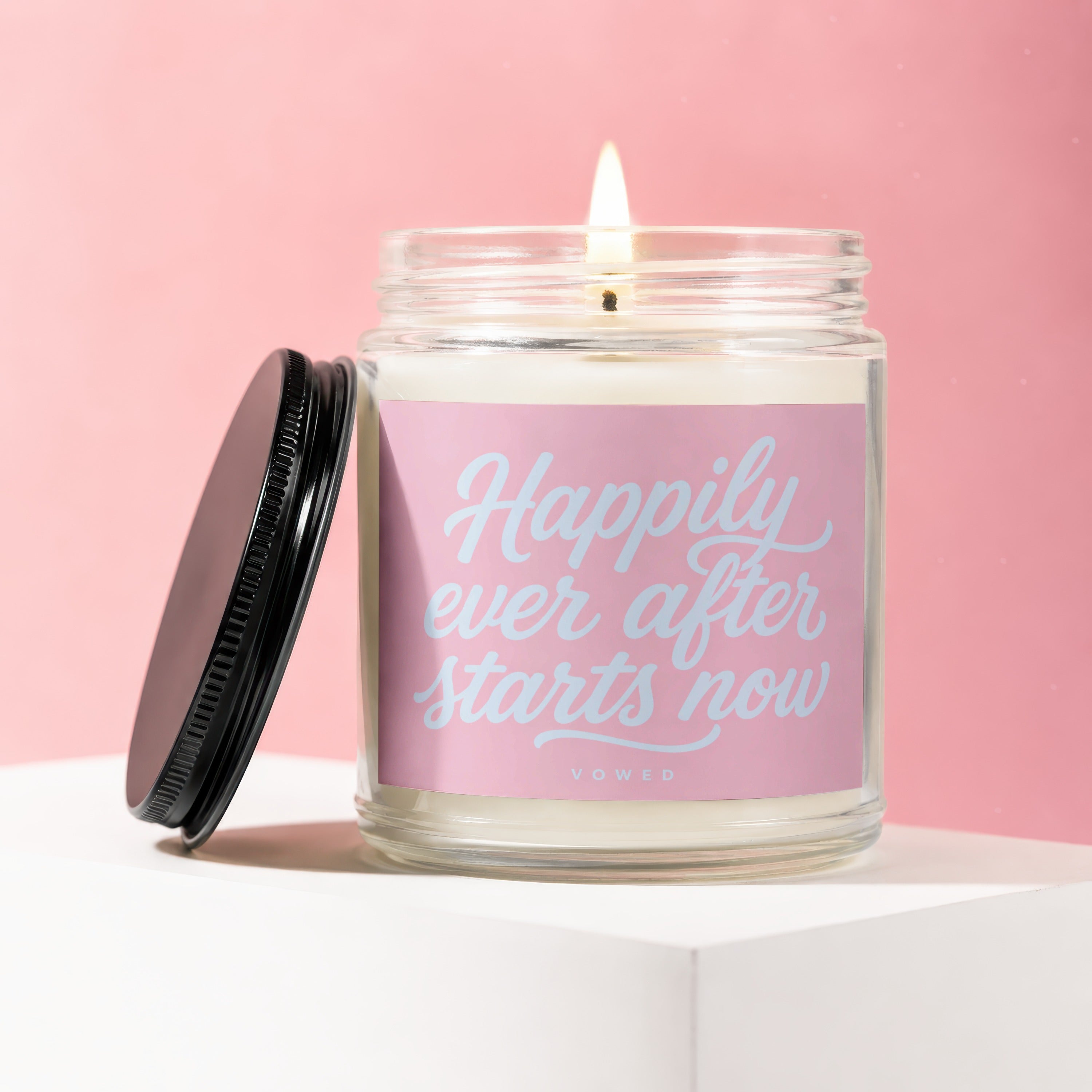 Jar candle with pink label reading "Happily ever after starts now"